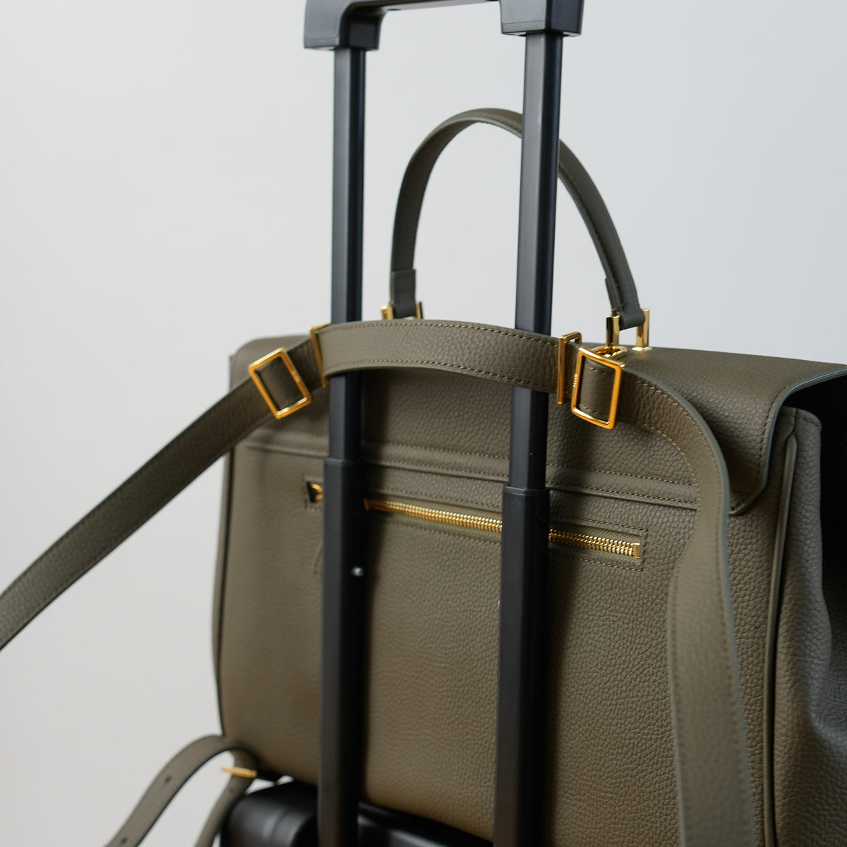 ALEMI Zurich | BELLEVUE | Laptop Bag | Olive Green | Soft Grain Leather | Bag on suitcase