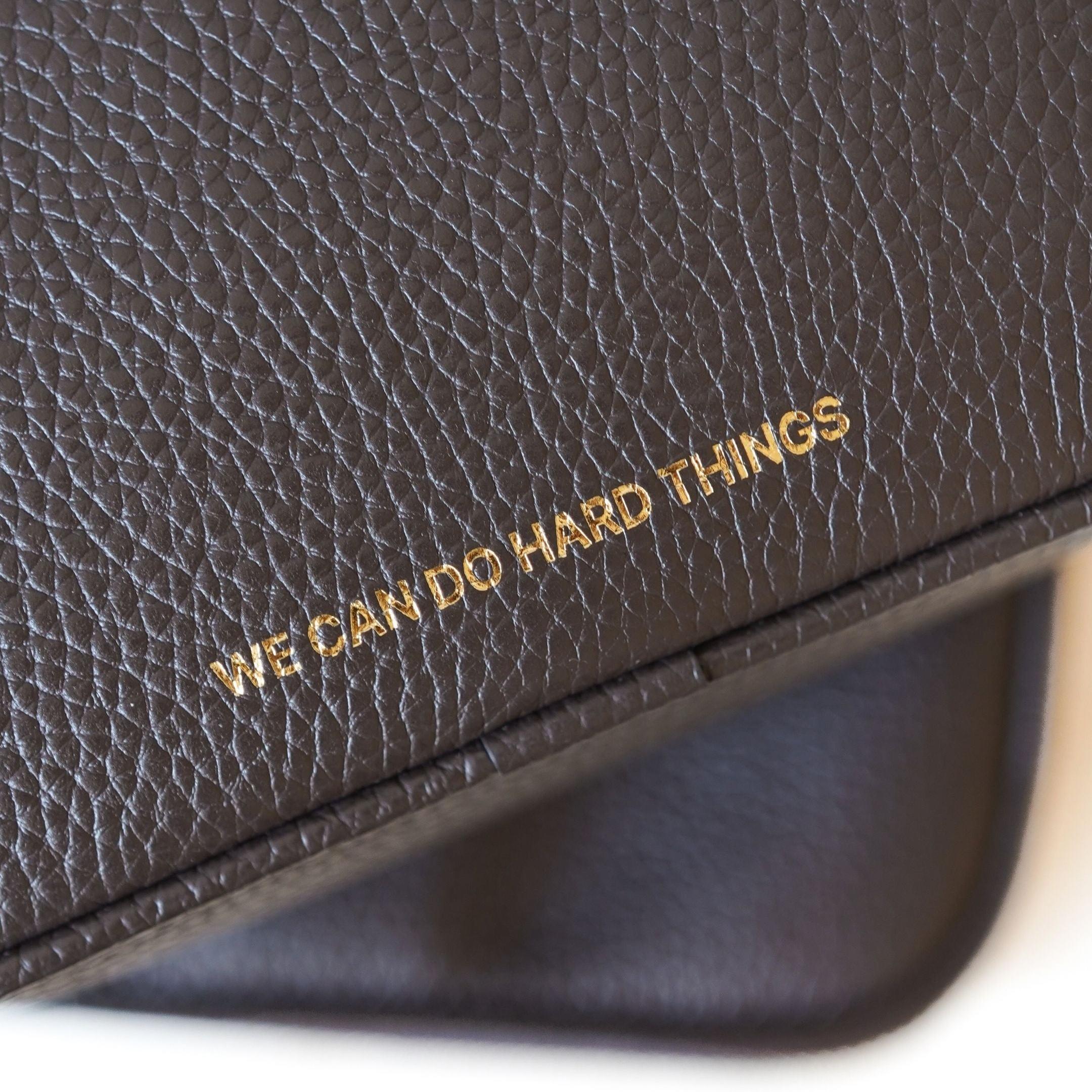 ALEMI Zurich | BELVOIR | Small Bag | Dark Brown Embossed | Soft Grain Leather | Bag slogan detail close-up