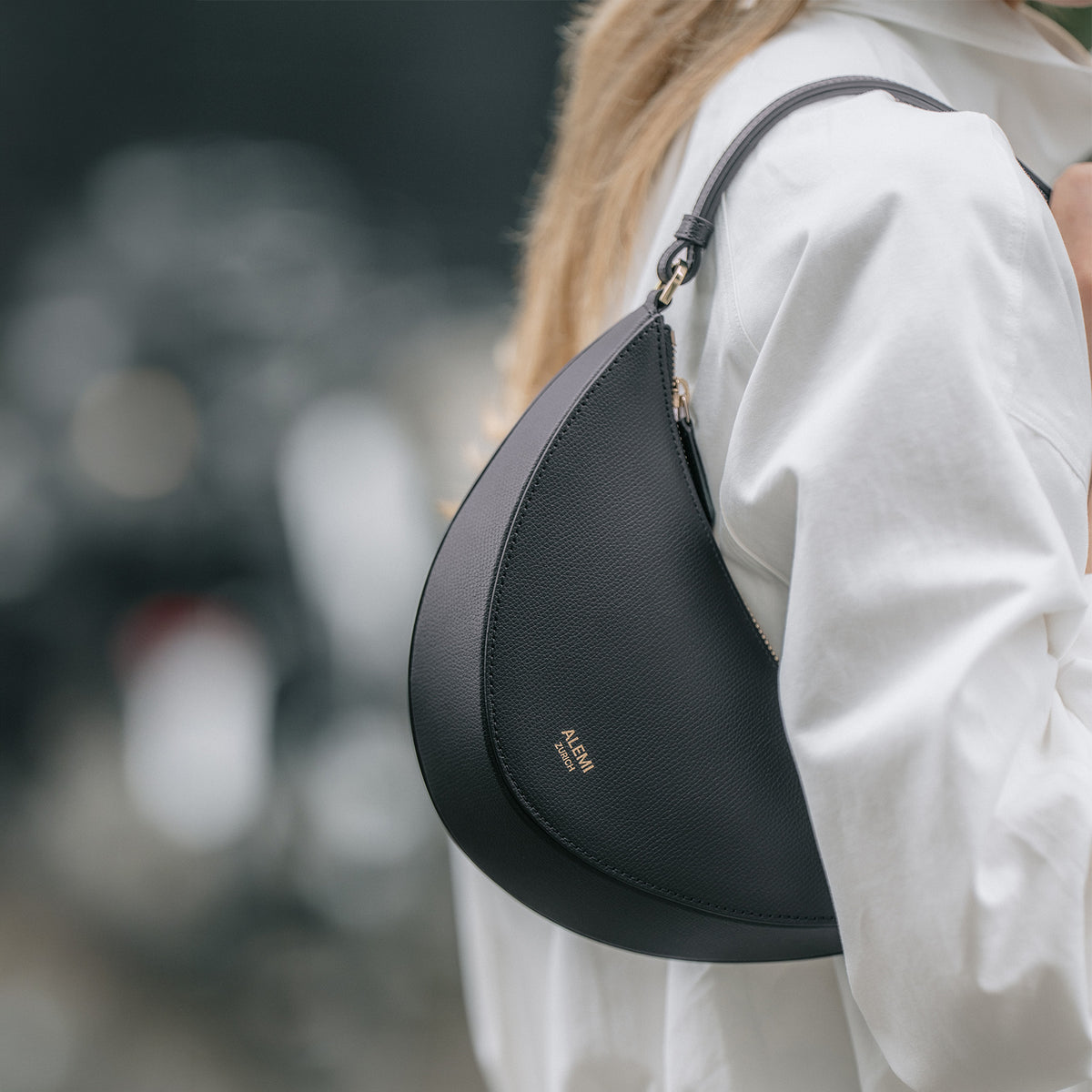 ALEMI Zurich | HELVETIA | Small Bag | Black | Pebbled Leather | Close up of bag on shoulder