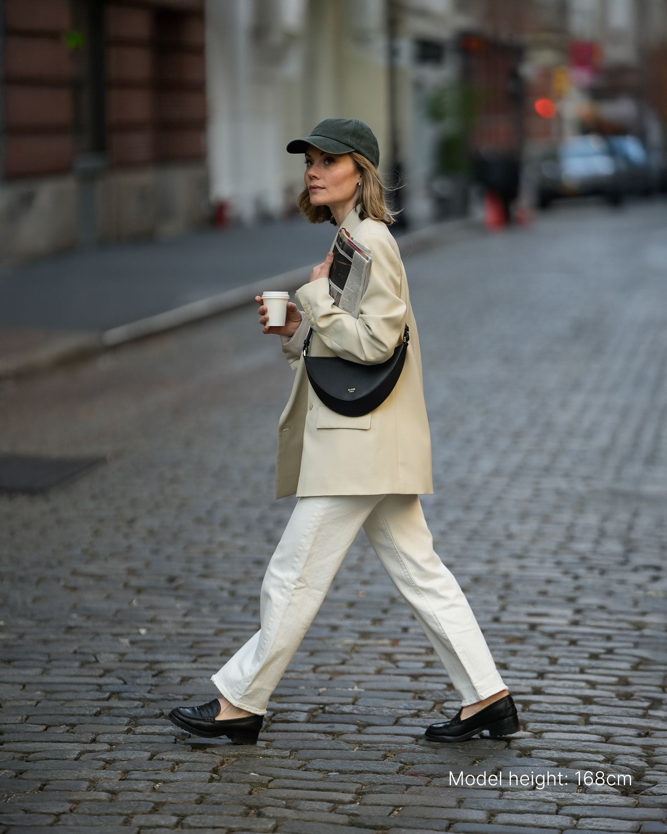ALEMI Zurich | HELVETIA | Small Bag | Black | Pebbled Leather | Model carrying bag cross body walking