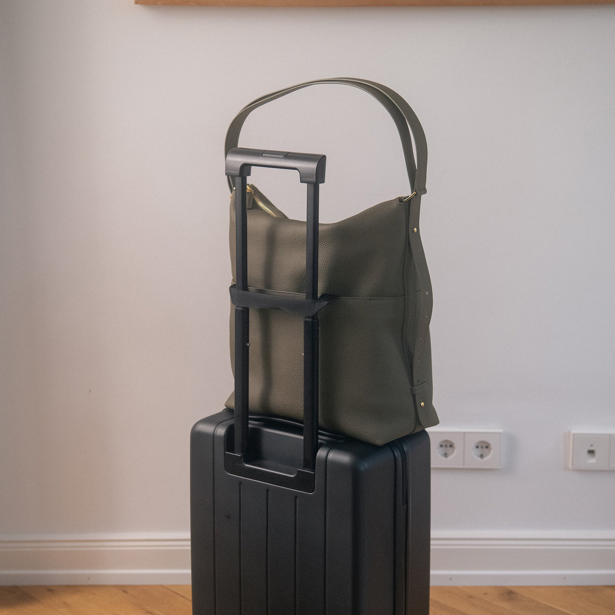 ALEMI Zurich | LETTEN | Laptop Bag | Olive Green | Soft Grain Leather | Bag on suitcase