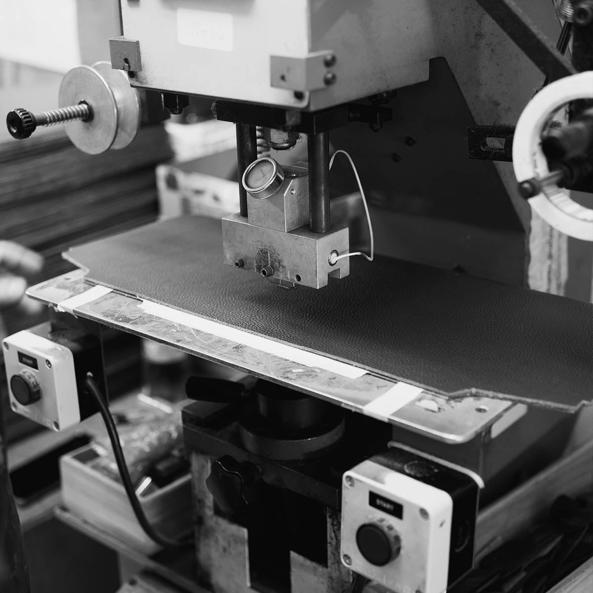 Leather cutting machine in the Italian family atelier where ALEMI bags are made