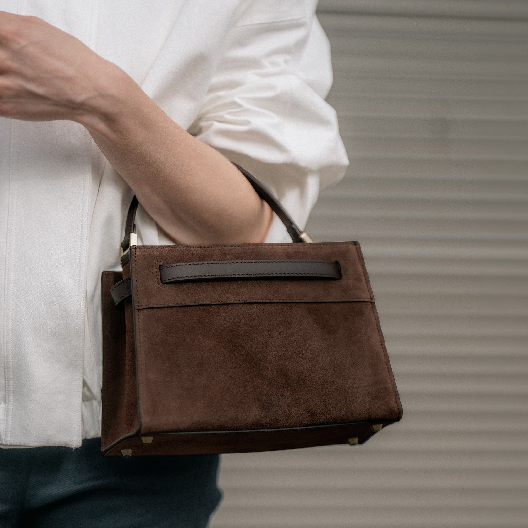 ALEMI Zurich | SEEFELD MINI | Small Bag | Dark Brown | Suede Leather | Close up of bag held by handle