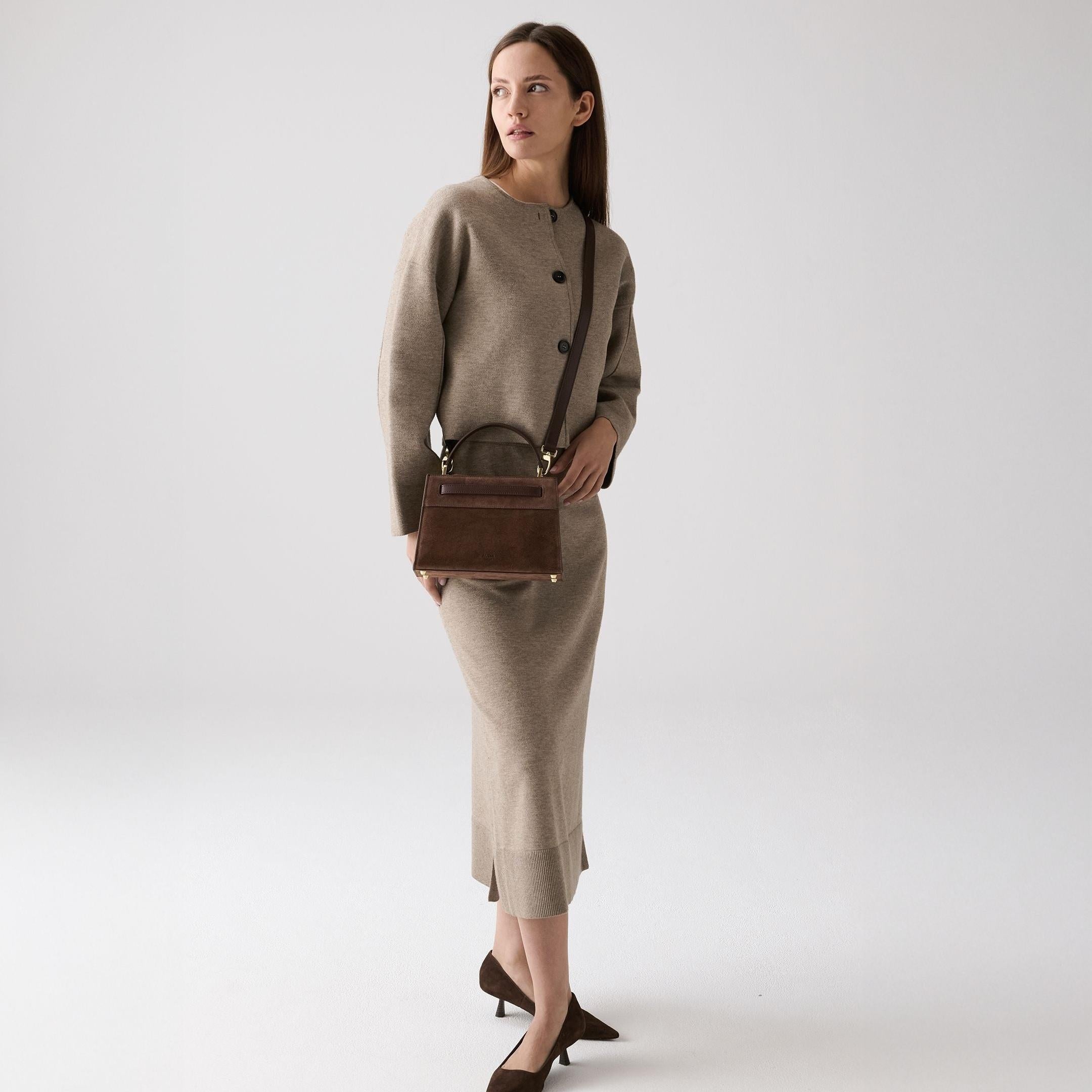 ALEMI Zurich | SEEFELD MINI | Small Bag | Dark Brown | Suede Leather | Model carrying bag by strap