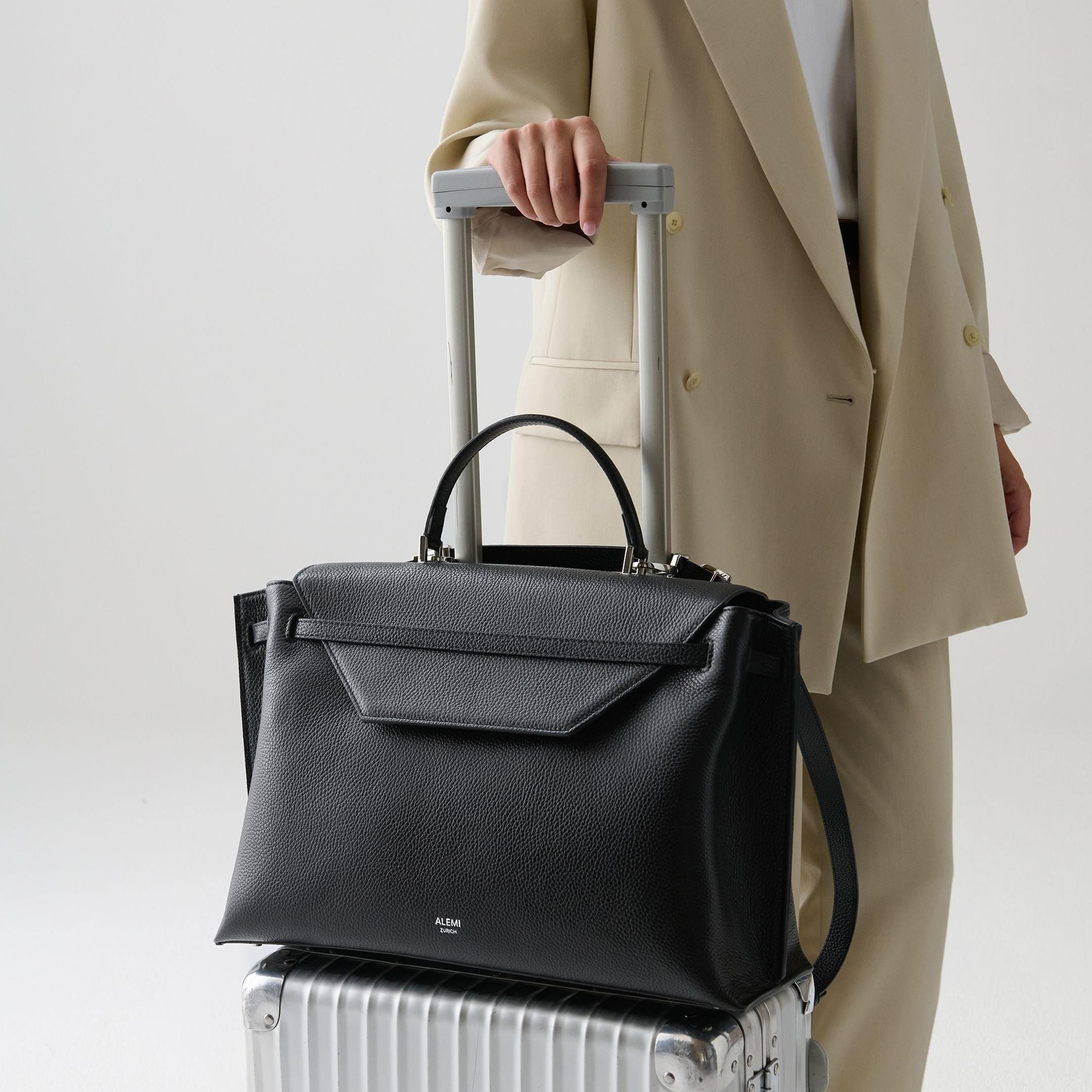 ALEMI Zurich | VIADUKT WORK | Laptop Bag | Black with Silver Hardware | Soft Grain Leather | Bag on luggage
