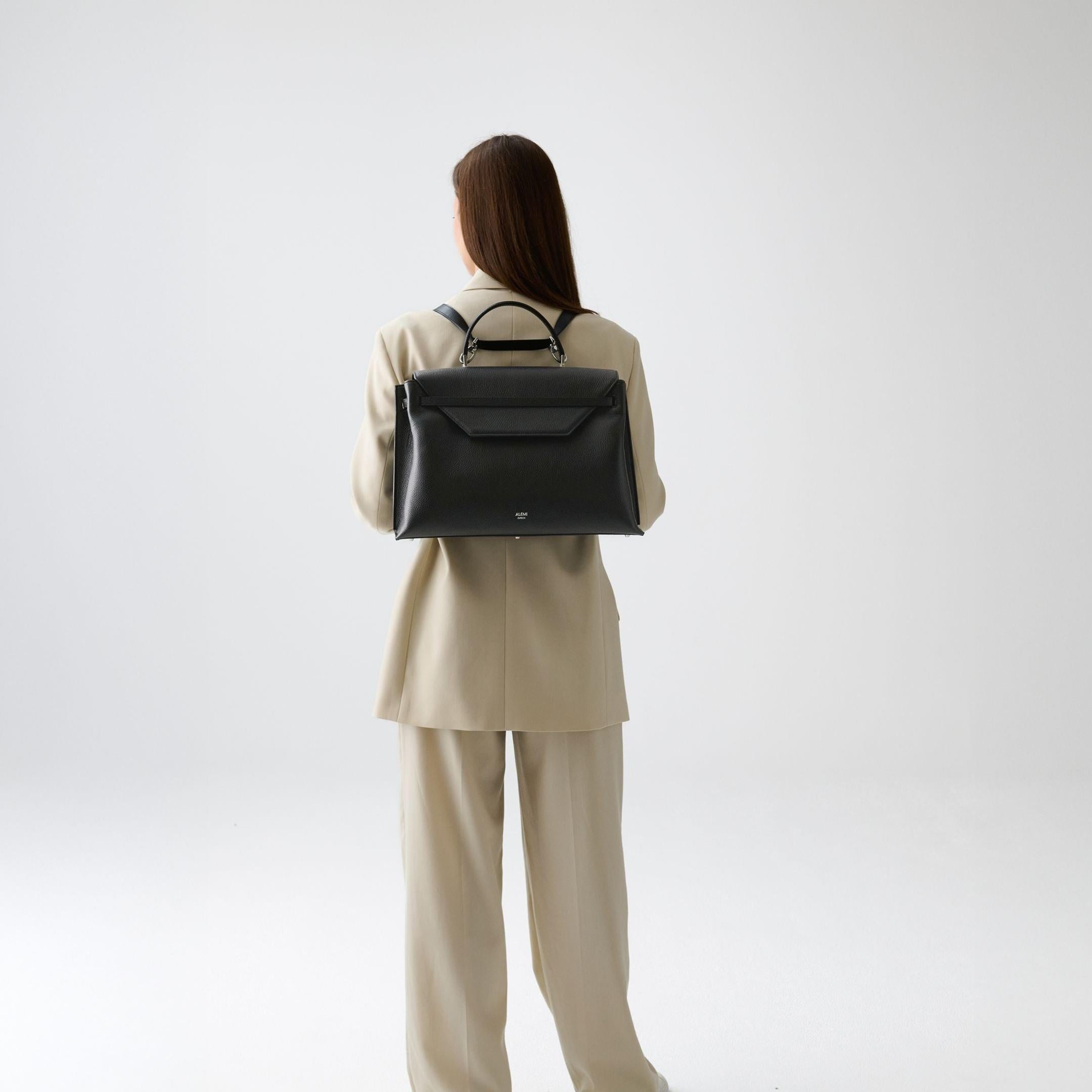 ALEMI Zurich | VIADUKT WORK | Laptop Bag | Black with Silver Hardware | Soft Grain Leather | Model carrying bag as backpack