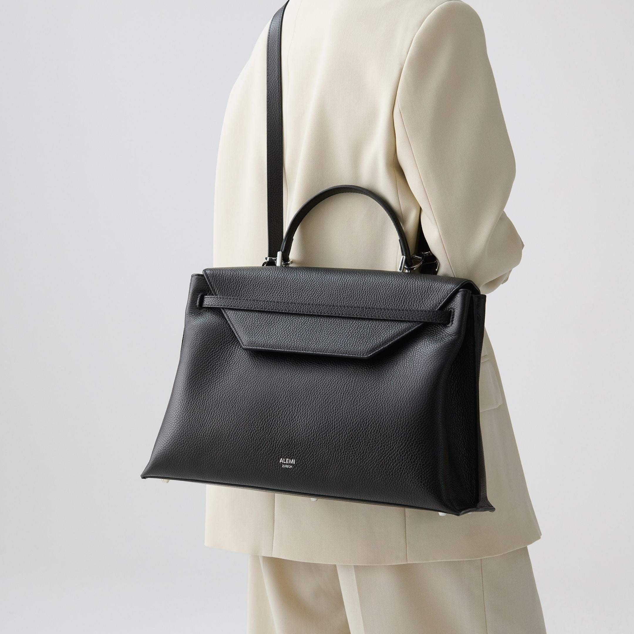 ALEMI Zurich | VIADUKT WORK | Laptop Bag | Black with Silver Hardware | Soft Grain Leather | Model carrying bag by strap