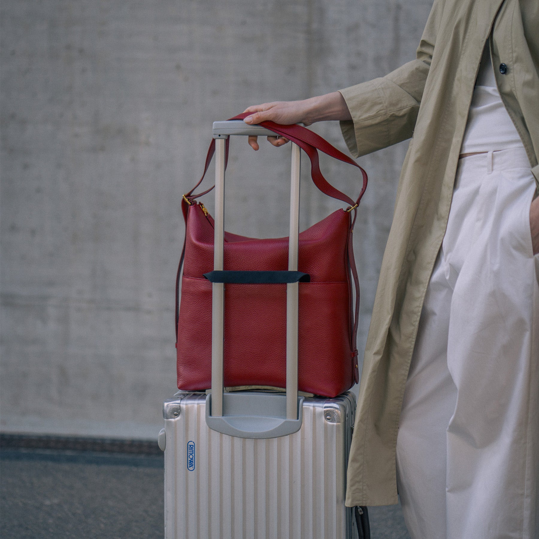ALEMI Zurich | LETTEN | Laptop Bag | Red | Soft Grain Leather | Bag on suitcase
