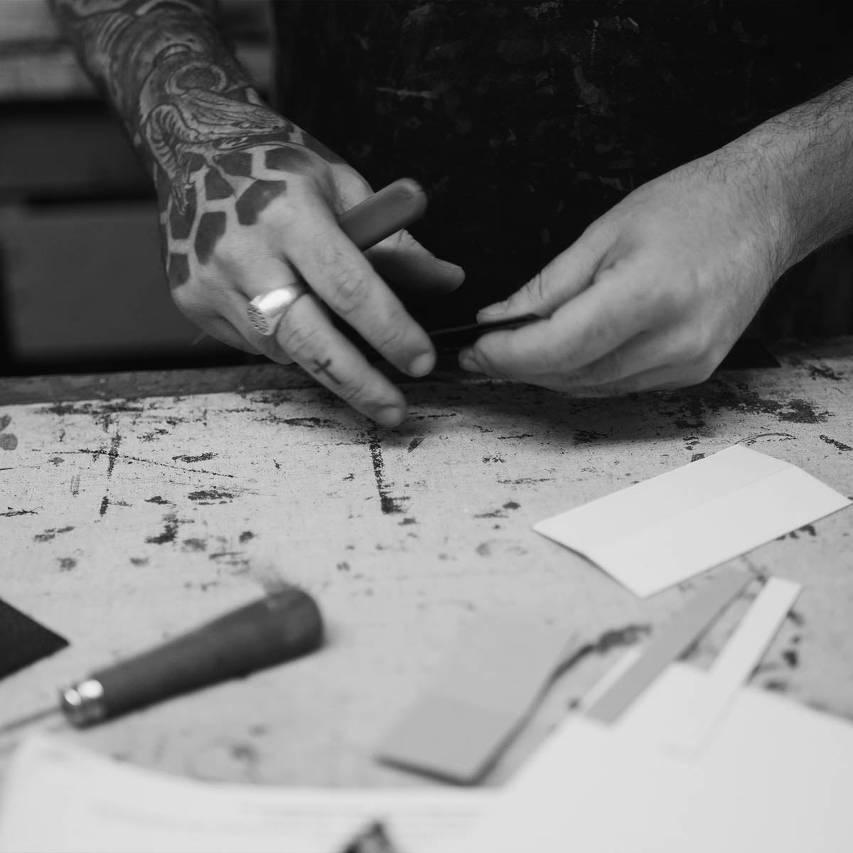 Craftsman marking Italian leather panels on the workbench before cutting