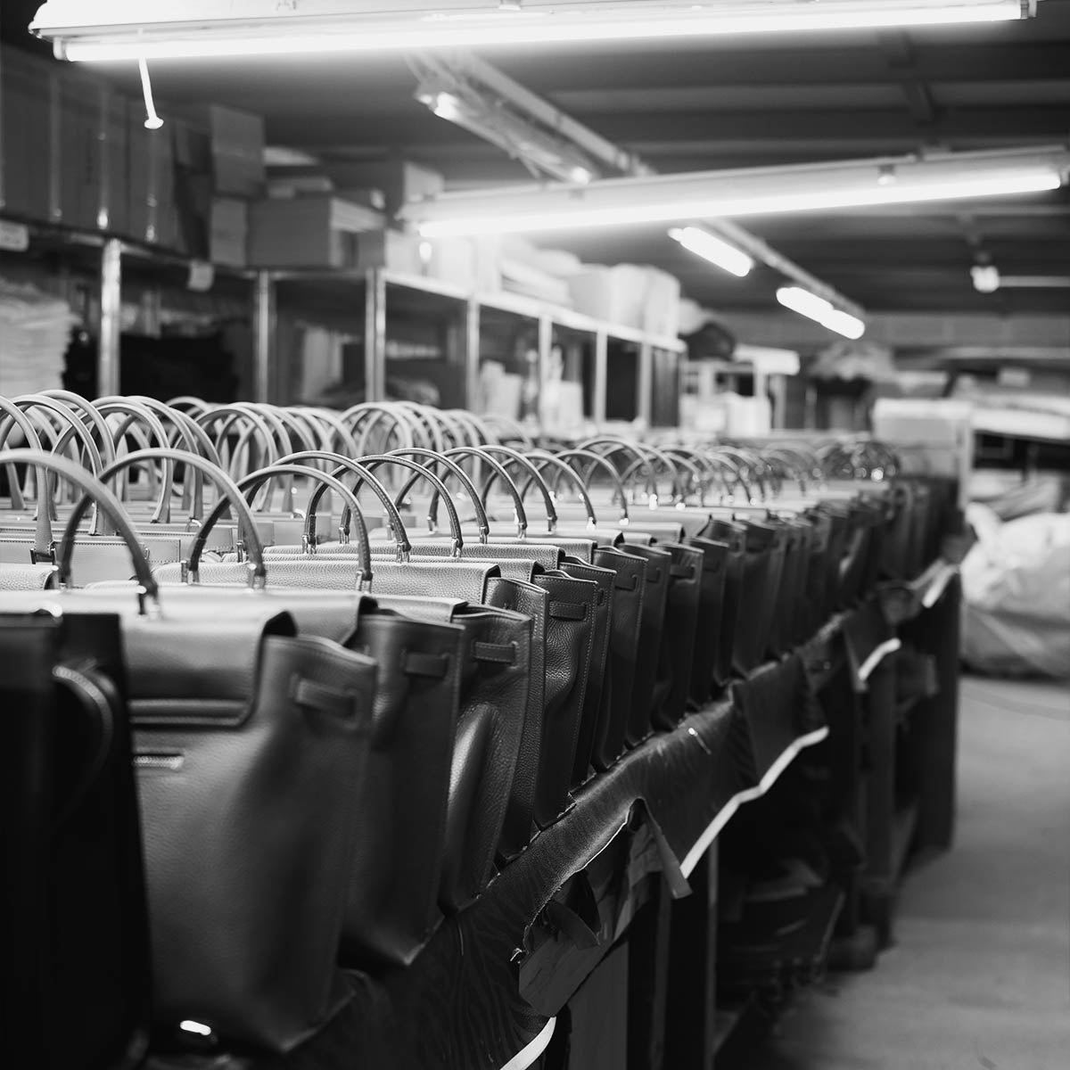 Row of ALEMI bags lined up in the Italian atelier during production